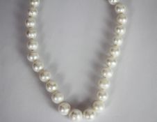 Pearl necklace, string of cultured pearls measuring approximately 12-13mm, stamped 9ct white gold