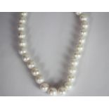 Pearl necklace, string of cultured pearls measuring approximately 12-13mm, stamped 9ct white gold