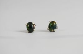 Pair of Black Opal stud earrings, each set with an oval cut black opal, 4 claw set, stamped sterling