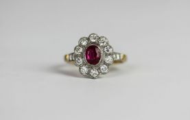 Burma Ruby and Diamond cluster ring, central oval cut Ruby, a cluster of Brilliant cut diamonds,