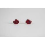 Pair of Ruby stud earrings, each set with an oval cut treated ruby, 4 claw set, stamped sterling