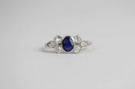 Sapphire & Diamond Bow ring, set with 1 oval cut sapphire approximately 0.72ct, set with 6 round