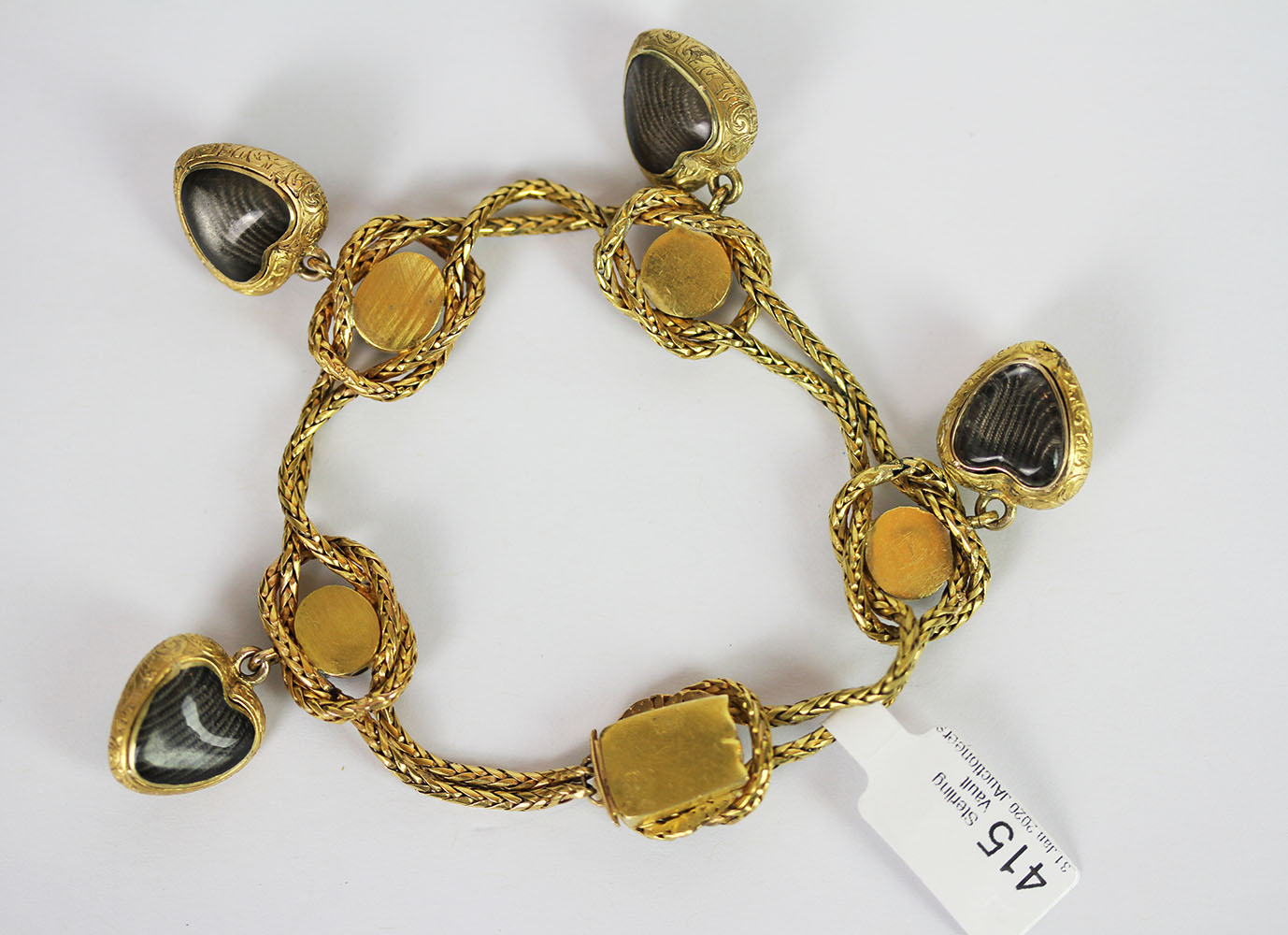 Garnet set charm bracelet, set with a total of 9 cabochon garnets, 4 dangling heart charms, not - Image 3 of 3