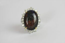 Black Opal and Diamond ring, set with a black opal approximately 13.16ct, surrounded by 24 round