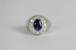 Diamond and blue stone cluster ring, set with 1 oval cut unknown blue stone, surrounded by 12