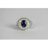 Diamond and blue stone cluster ring, set with 1 oval cut unknown blue stone, surrounded by 12