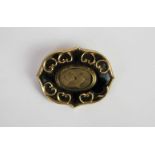 Victorian black enamel mounting locket, central hair display, black enamel border with gold