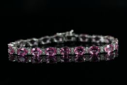 14ct White Gold Sapphire and Diamond bracelet featuring, 19 oval cut, pink Sapphires (15.75ct