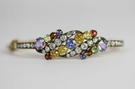 Edwardian Multi-coloured gem set bangle, set with a total of 39 gems including blue, yellow and