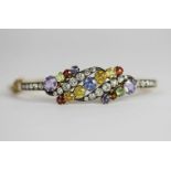 Edwardian Multi-coloured gem set bangle, set with a total of 39 gems including blue, yellow and