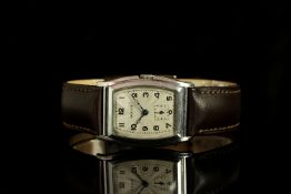 GENTLEMENS ROLEX WRISTWATCH CIRCA 1930, tonneau guilloche two tone dial with black arabic numeral