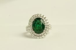 18CT WHITE GOLD EMERALD AND DIAMOND RING 4 CLAW SET, EMERALD ESTIMATED AT 3.70CT, and vivid medium