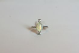 Opal & Diamond ring, set with 1 opal approximately 1.35ct, 8 claw set, surrounded by 2 round