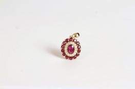 14K RUBY AND DIAMOND PENDANT ,centre stone estimated as 0.65ct, with 30 rubies estimated as 0.21ct