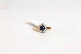 Sapphire and Diamond cluster ring, set with a round sapphire approximately 0.79ct, surrounded by