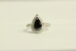 14K WHITE GOLD SET WITH A BLACK DIAMOND AND WHITE DIAMOND CLUSTER RING, centre stone estimated at