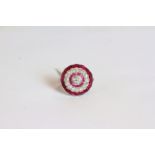 Ruby and Diamond dress ring, set with a central old-cut diamond, a halo of rubies, a halo of