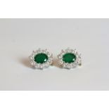 Pair of Emerald and Diamond cluster stud earrings, set with a total of 2 oval cut emeralds totalling