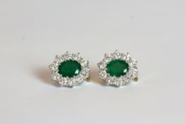 Pair of Emerald and Diamond cluster stud earrings, set with a total of 2 oval cut emeralds totalling