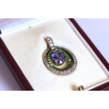 Sapphire, Tsavorite Garnet and Diamond set pendant, set with 1 oval cut sapphire approximately 2.