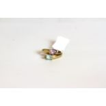 9CT BLUE AND PURPLE TWO STONE CROSSOVER RING,tested 9ct, total weight 2.36gms, ring size L.