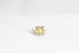 Opal and diamond cluster ring, large round cabochon cut opal approximately 11.5mm, set within a