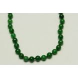 Jade bead necklace, approximately 6mm Jade beads strung knotted, a diamond set clasp,