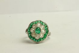 Emerald and Diamond Daisy Style Ring, set with emeralds totalling approximately 1.45ct