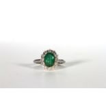 Emerald and Diamond cluster ring, set with an oval cut emerald totalling approximately 1.64ct