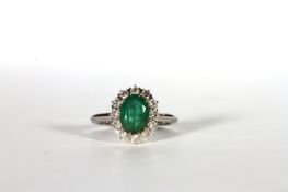 Emerald and Diamond cluster ring, set with an oval cut emerald totalling approximately 1.64ct