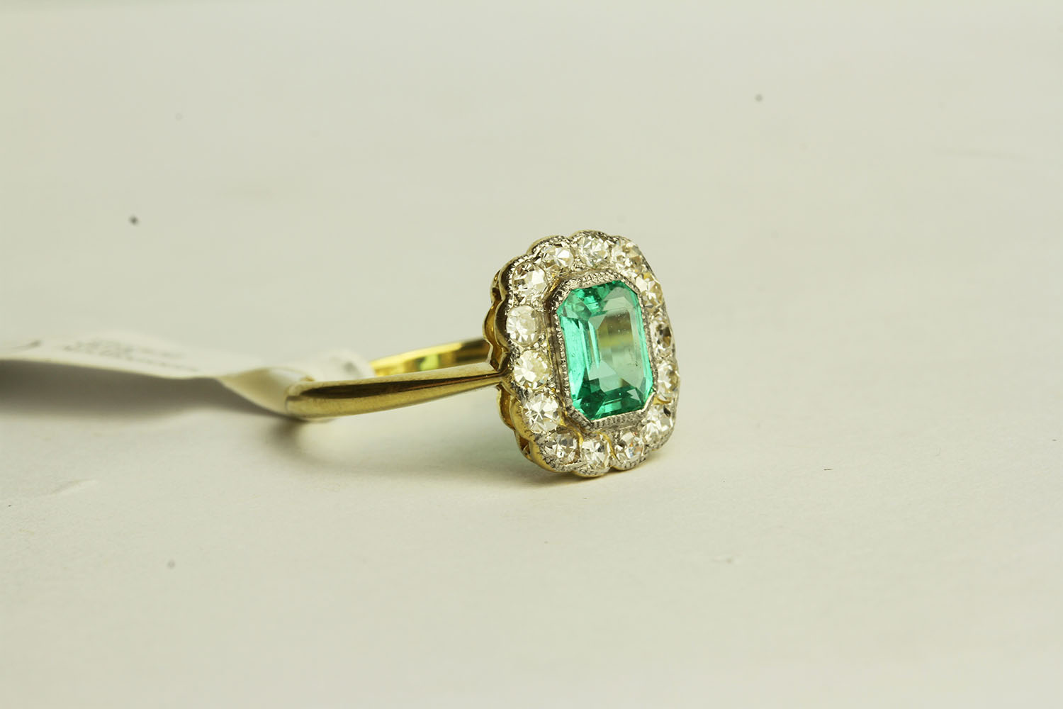 Emerald and Diamond Ring, set with a centre emerald approximately 0.64ct, surrounded by 14 - Image 2 of 3