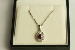 Ruby and Diamond Cluster Necklace, set with 1 oval cut ruby approximately 0.33ct