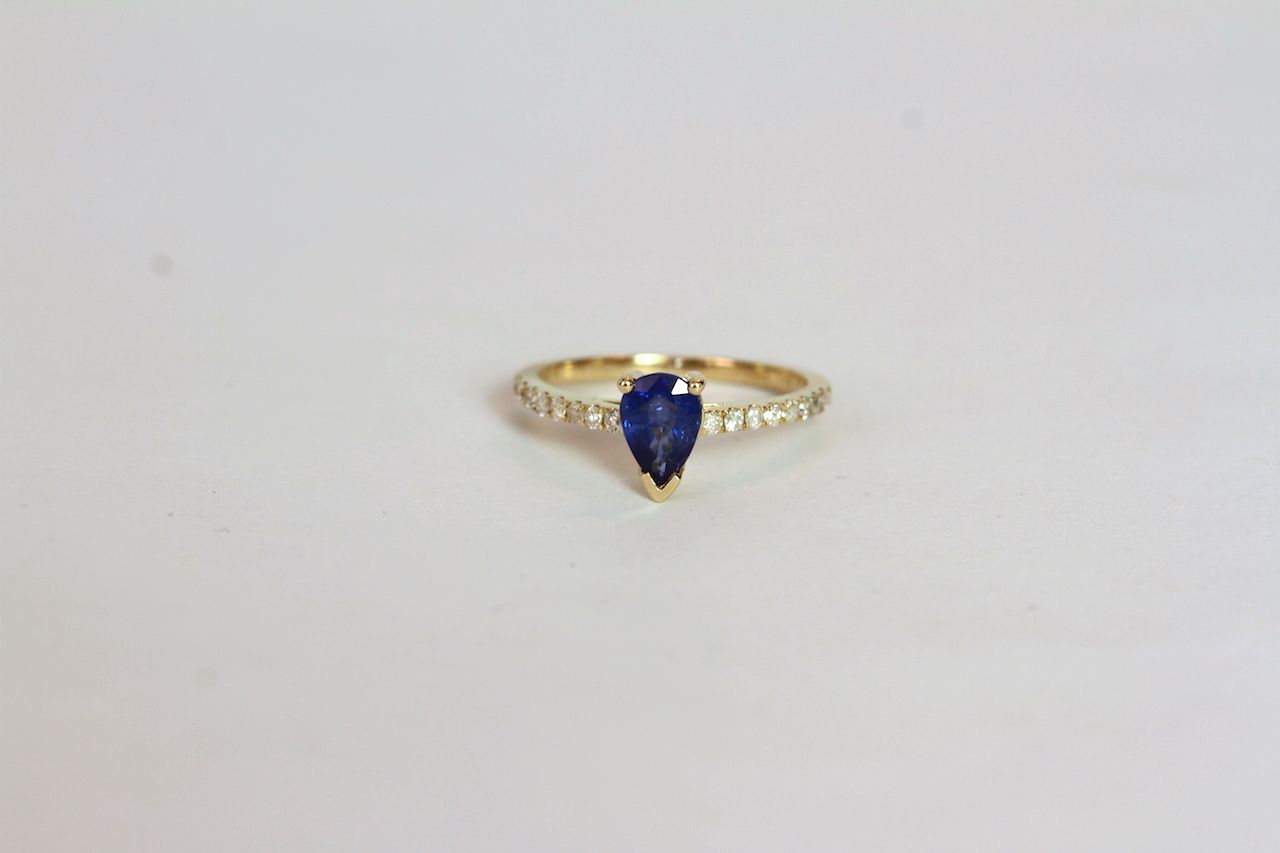 Sapphire and Diamond ring, set with a pear cut medium blue sapphire totalling approximately 0.84ct