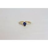 Sapphire and Diamond ring, set with a pear cut medium blue sapphire totalling approximately 0.84ct