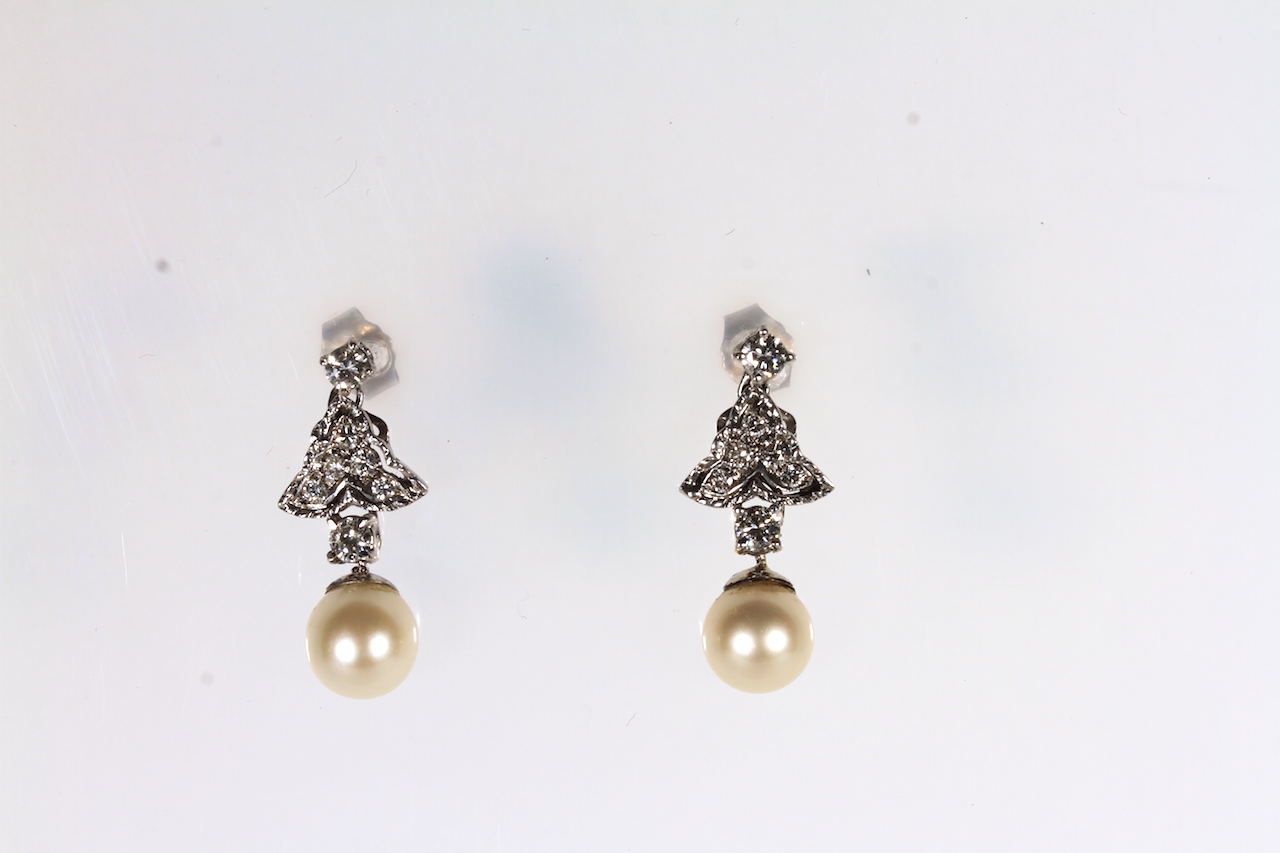 Pearl and diamond drop earrings, a suspended 8mm pearl, from articulated diamond set drops, post and