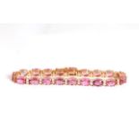 Pink Sapphire and Diamond bracelet, set with 19 oval cut pink sapphires totalling approximately 15.