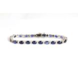 Sapphire and Diamond bracelet, set with 21 oval cut sapphires totalling approximately 11.24ct