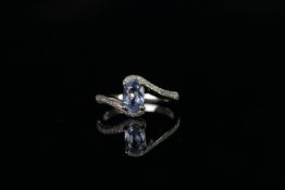 Sapphire and Diamond twist ring, set with 1 oval cut natural sapphire approximately 0.82ct