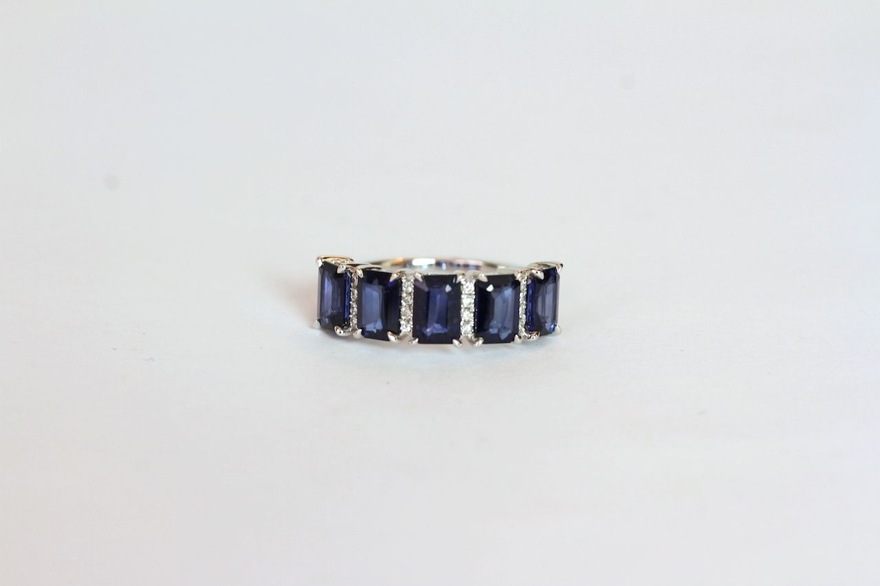 Sapphire and Diamond ring, set with 5 emerald cut sapphires totalling approximately 3.43ct, 24 round
