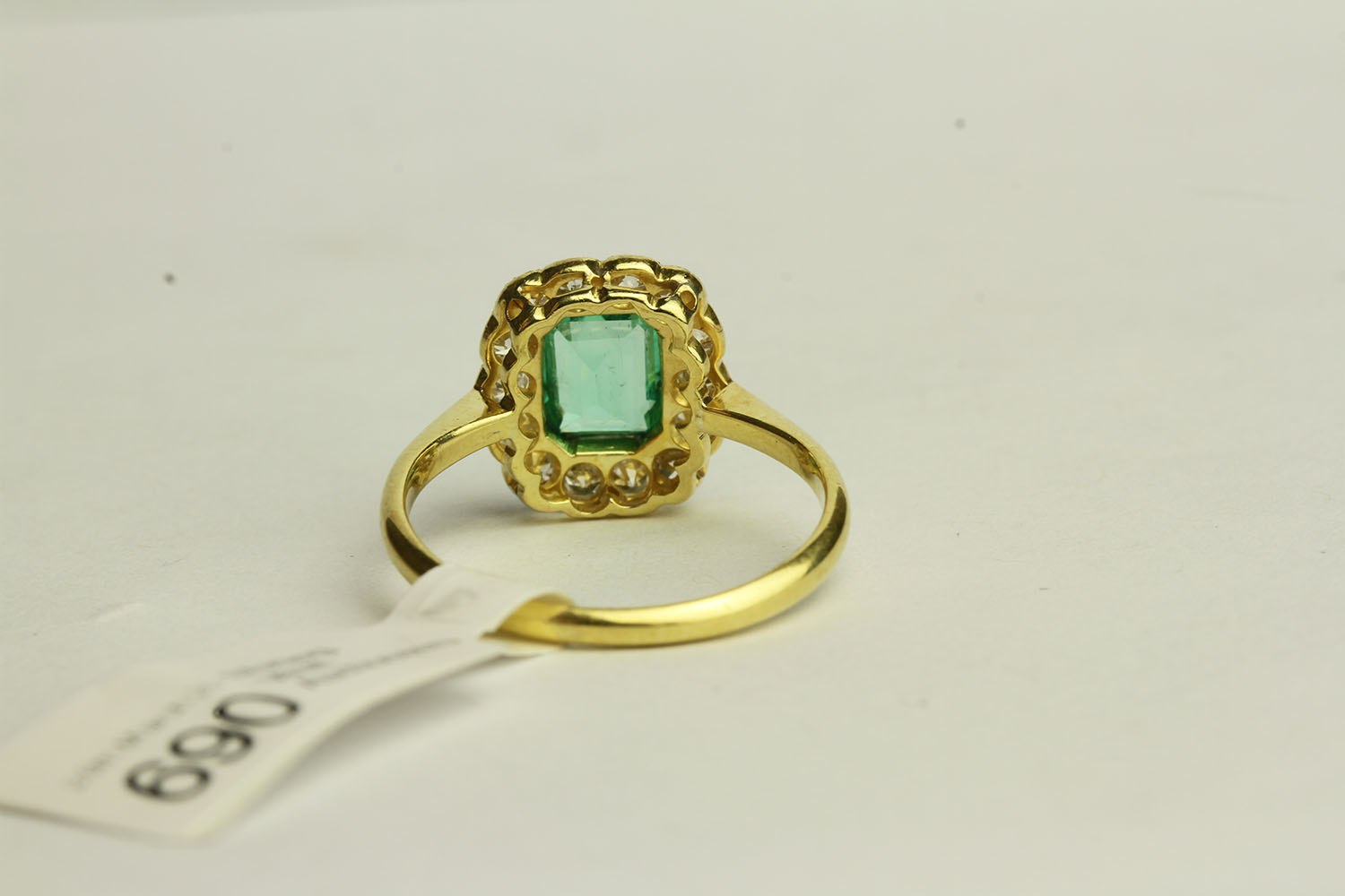 Emerald and Diamond Ring, set with a centre emerald approximately 0.64ct, surrounded by 14 - Image 3 of 3