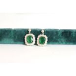 Pair of Emerald and Diamond drop earrings, set with 2 oval cut medium green emeralds