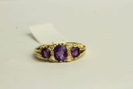Amethyst and Diamond Ring, set with 3 amethysts and 4 diamonds, stamped 18ct yellow gold, finger