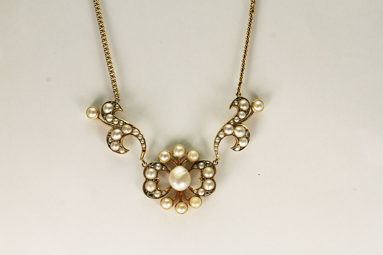 Edwardian Pearl and Diamond Pendant, set with pearls and old cut diamonds, approximate chain