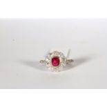 Ruby and Diamond Flower Ring, set with a ruby approximately 0.70ct, surrounded by diamonds totalling