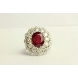 Ruby and Diamond Cluster Ring, set with an oval cut ruby approximately 5.67ct