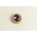 Amethyst and Pearl Brooch, set with a centre amethyst, surrounded by pearls.