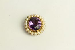Amethyst and Pearl Brooch, set with a centre amethyst, surrounded by pearls.