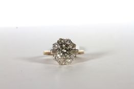 Diamond Cluster Ring, set with a central diamond approximately 0.73ct, surrounded by 2 baguette