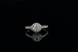 Diamond cluster ring, set with 1 round brilliant cut diamond approximately 0.72ct