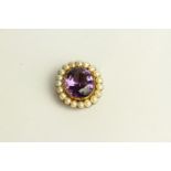 Amethyst and Pearl Brooch, set with a centre amethyst, surrounded by pearls.